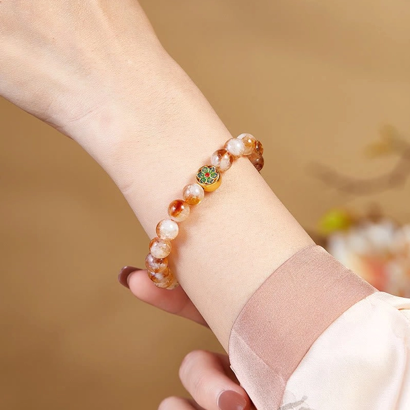Citrine Om Mani Padme Hum bracelet worn on human wrist close-up showing fit comfort and enamel charm detail