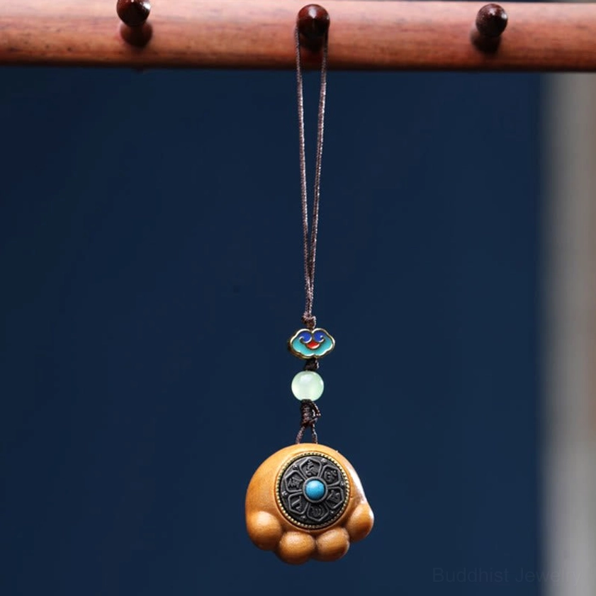 Classic sandalwood cat paw phone charm with enamel and jade bead decorations on wooden display stand