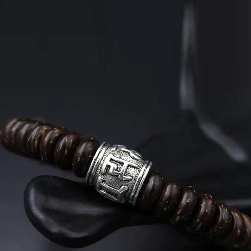 Coconut shell bracelet representing Buddhist philosophy of compassion, wisdom, and path to enlightenment