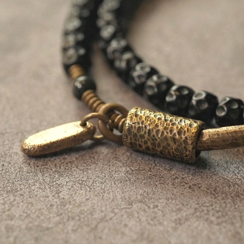 Close-up low-angle view of coconut shell triple wrap bracelet hammered brass detail