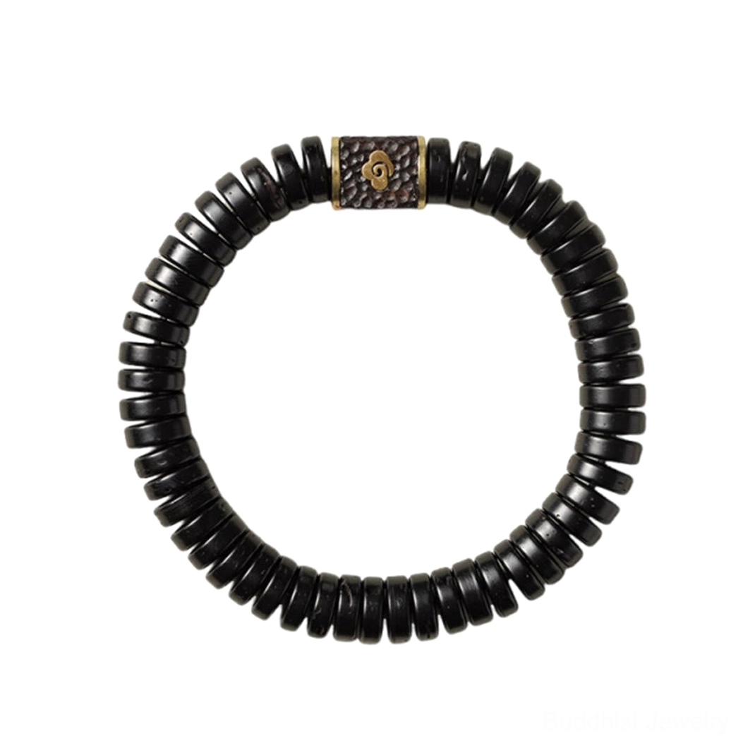 Handcrafted coconut shell bracelet held in hands showing flexibility and natural material quality