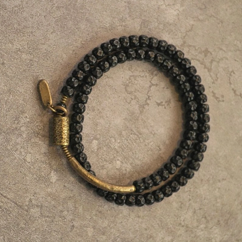 Unfolded triple wrap coconut shell bracelet with lobster claw clasp extended view