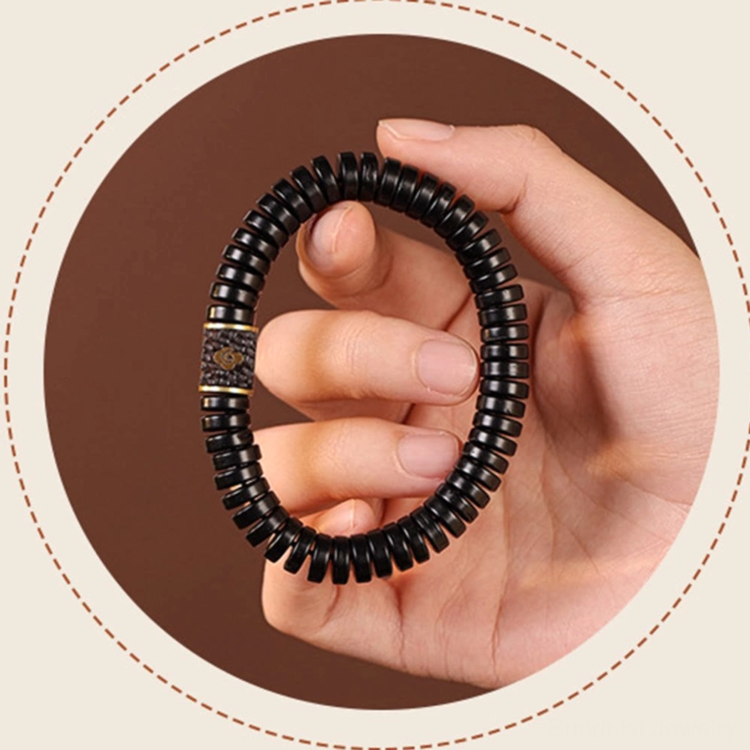 Spiritual coconut shell bracelet worn on human wrist against dark brown background