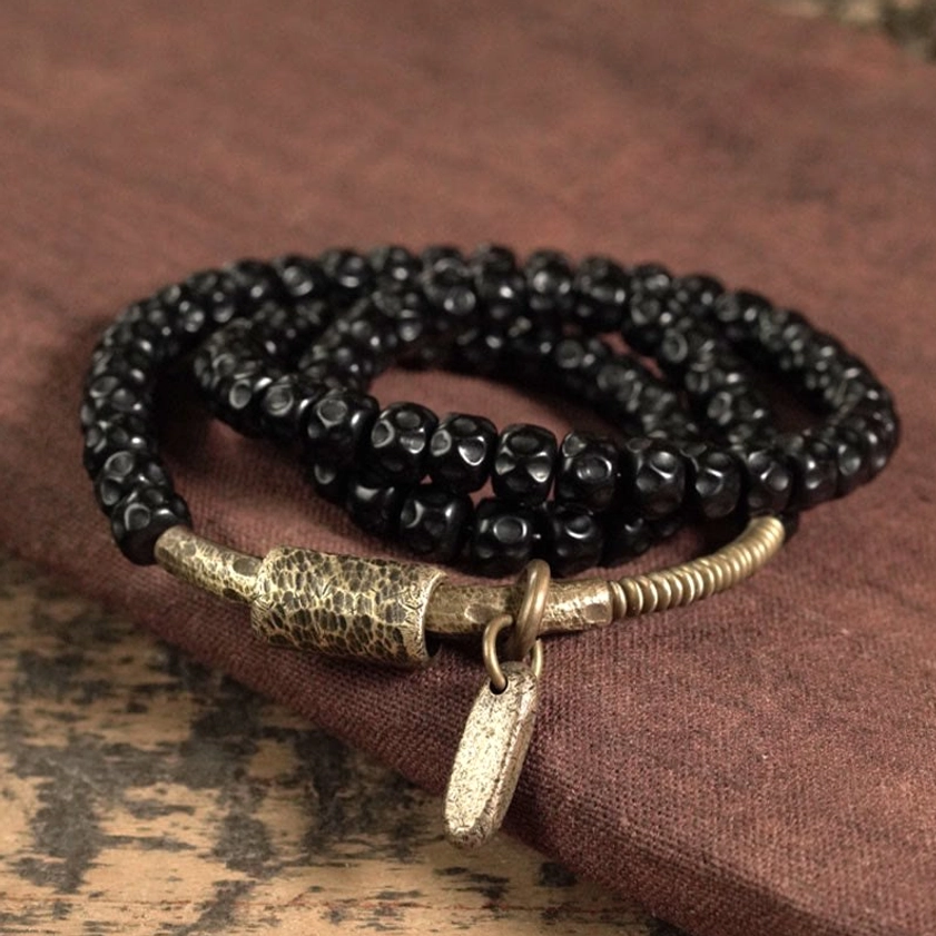 Handcrafted coconut shell beads with brass hardware triple wrap bracelet angled view