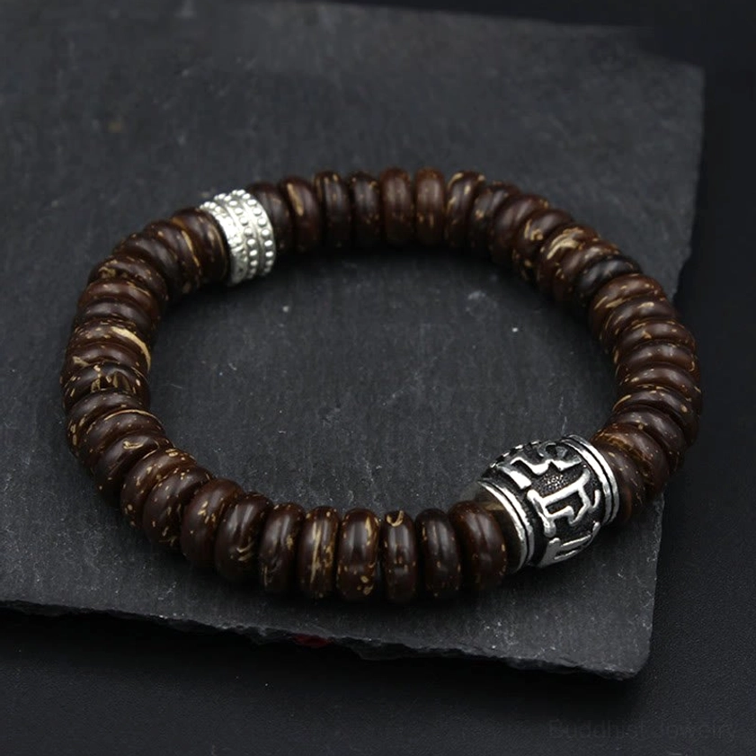 Brown coconut shell bracelet with antique silver metal spacers and engraved Sanskrit mantra bead detail