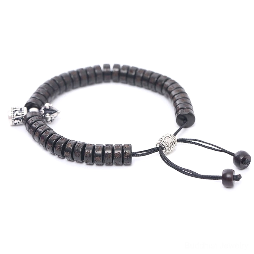 Side view of Om Mani Padme Hum bracelet showing dual silver charm pendants and coconut disc beads with adjustable string
