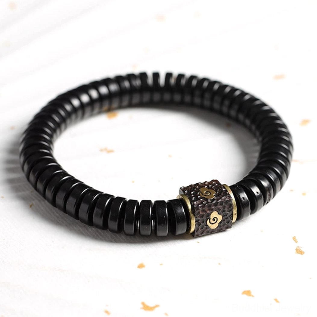 Natural coconut shell bracelet with uniform black disc beads and golden speckle background