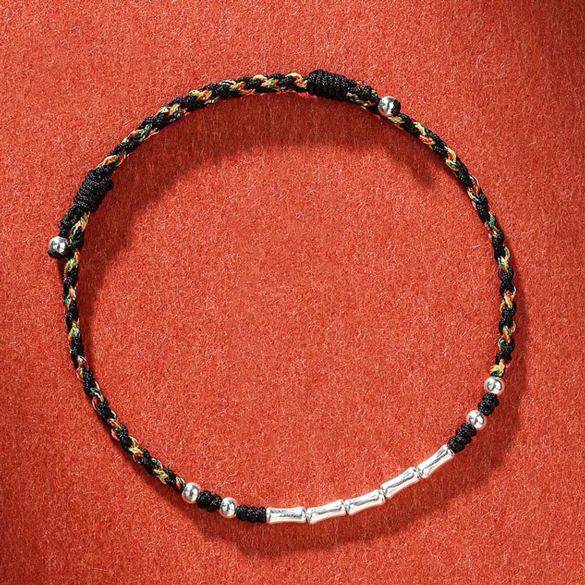 Colorful black multicolored braided Buddhist protection bracelet with metal accents