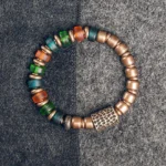 Colorful glass beads copper bracelet flat lay top-down view showing vibrant mixed bead pattern and antique copper spacer beads