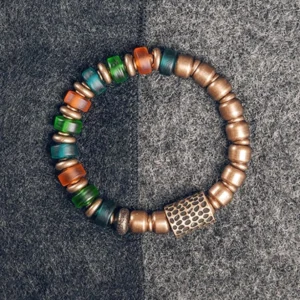 Colorful glass beads copper bracelet flat lay top-down view showing vibrant mixed bead pattern and antique copper spacer beads