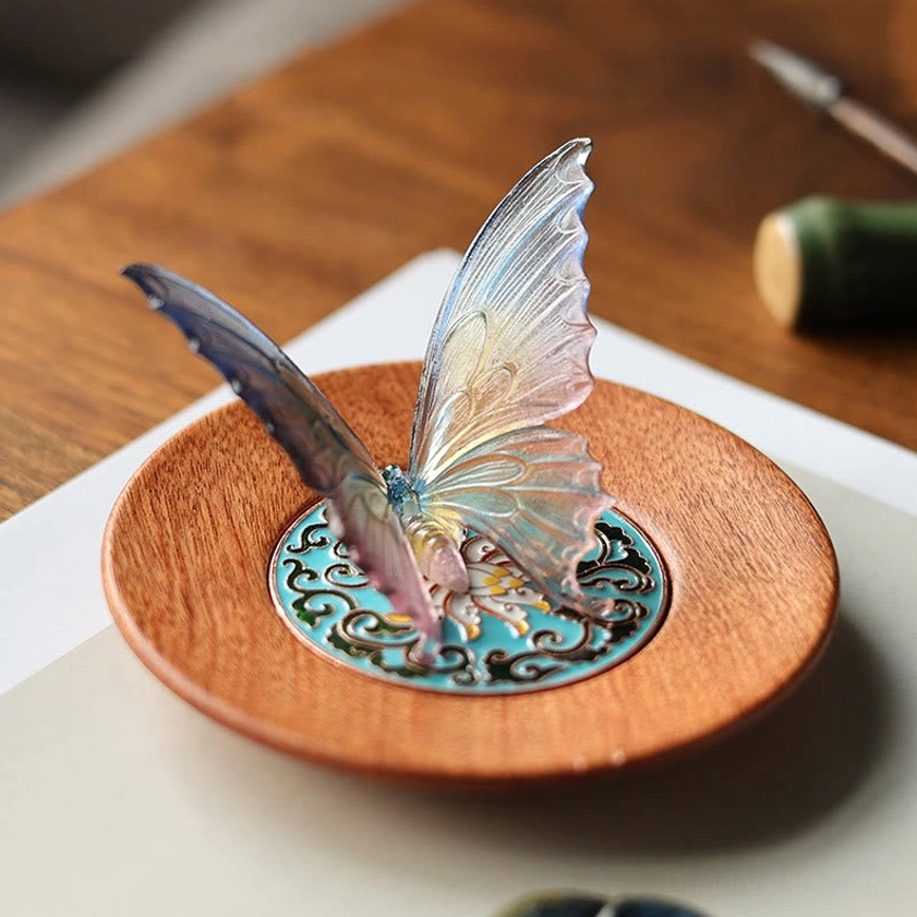Gradient multicolor butterfly incense burner with blue-yellow-pink glass wings on wooden desk
