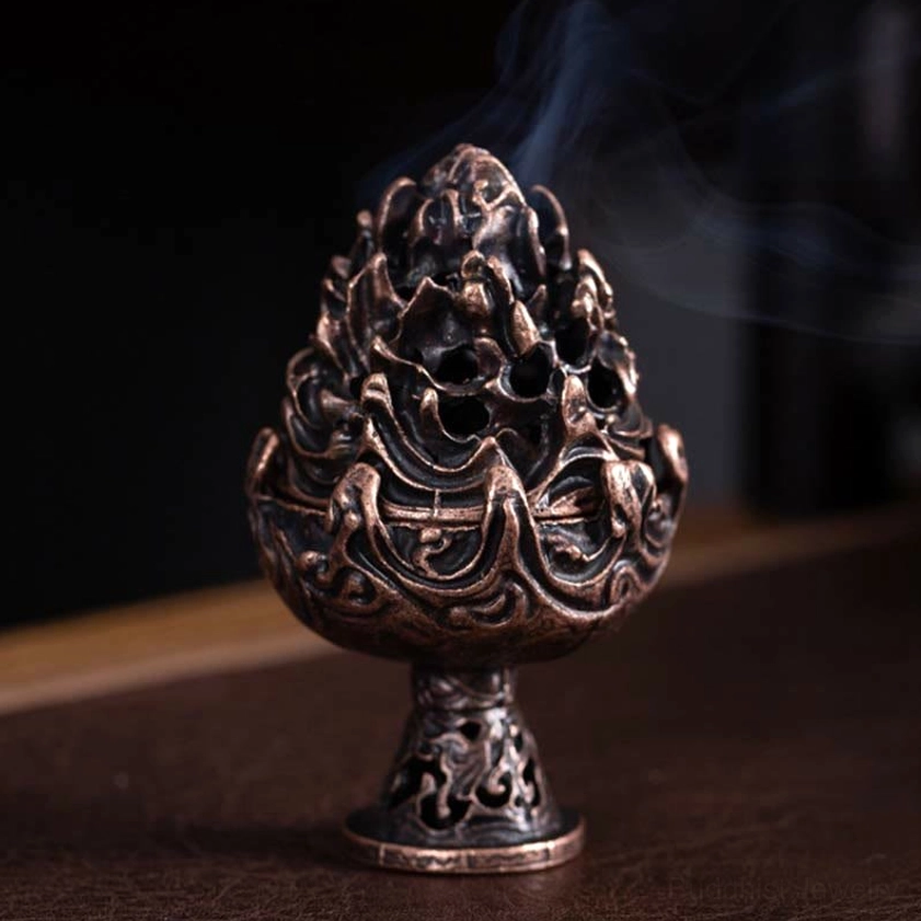 Small Buddhist incense burner bronze finish close-up showing mountain relief carving details and compact size for personal meditation
