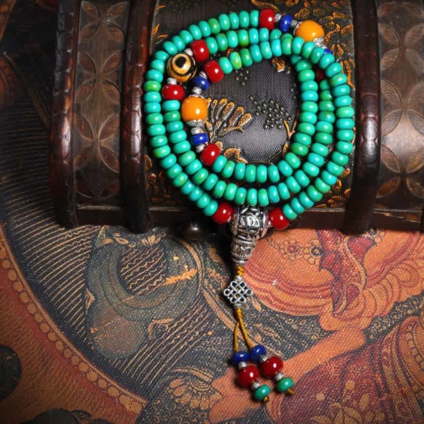 Complete 108-bead Buddhist mala prayer bracelet set with turquoise and gemstone mix on wooden chest