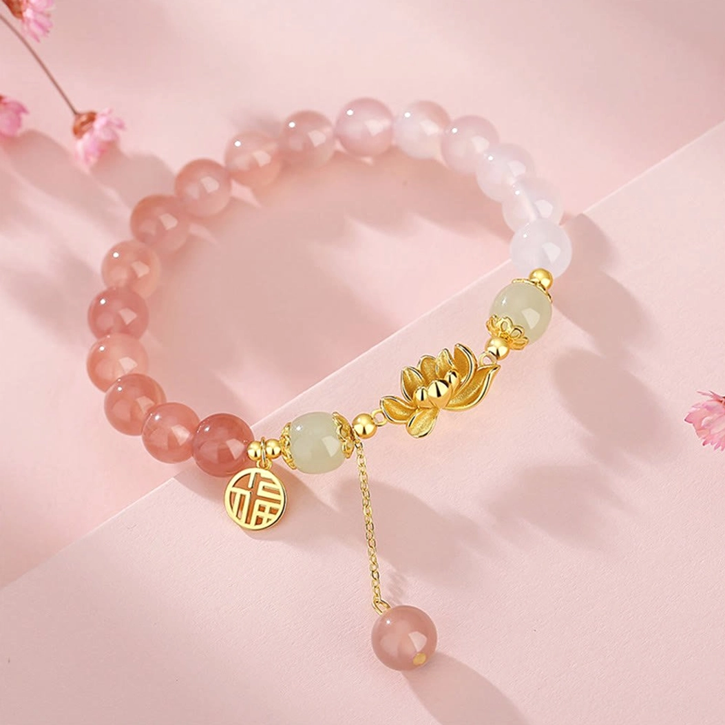 Complete Buddhist bracelet with agate beads, Hetian jade accents, gold lotus and Fu character ornaments on cherry blossom background