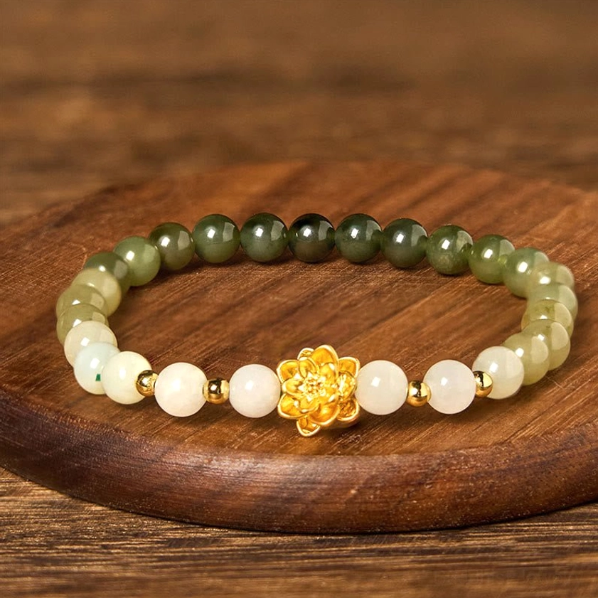 Complete Hetian jade lotus bracelet showing full circular strand with color gradient, gold lotus pendant, and spacer beads