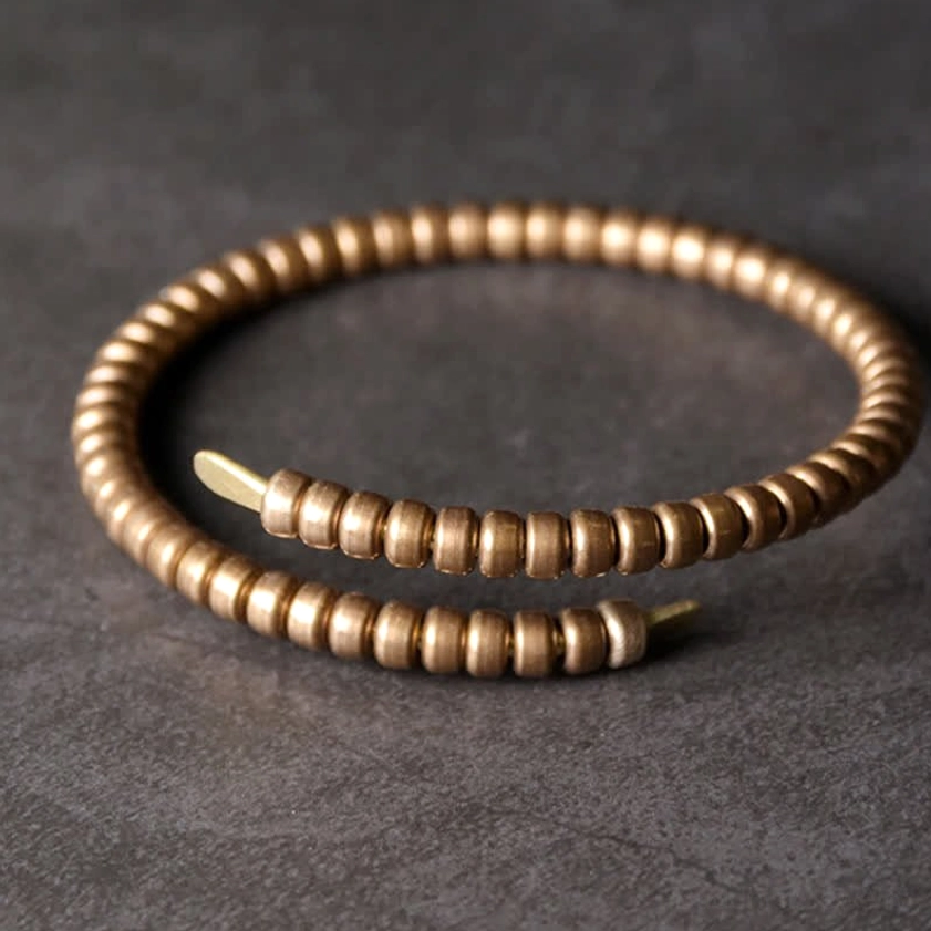 Pair of vintage copper balance cuff bracelets, angled view showing open adjustable cuff design