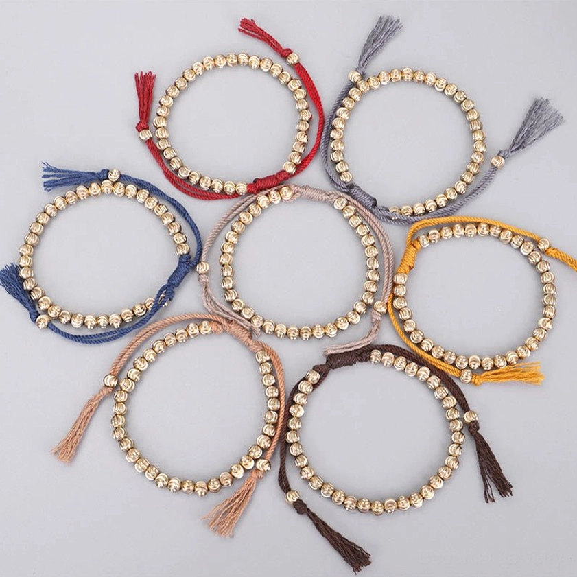 Close-up of copper bead texture and cotton cord craftsmanship on Buddhist bracelet