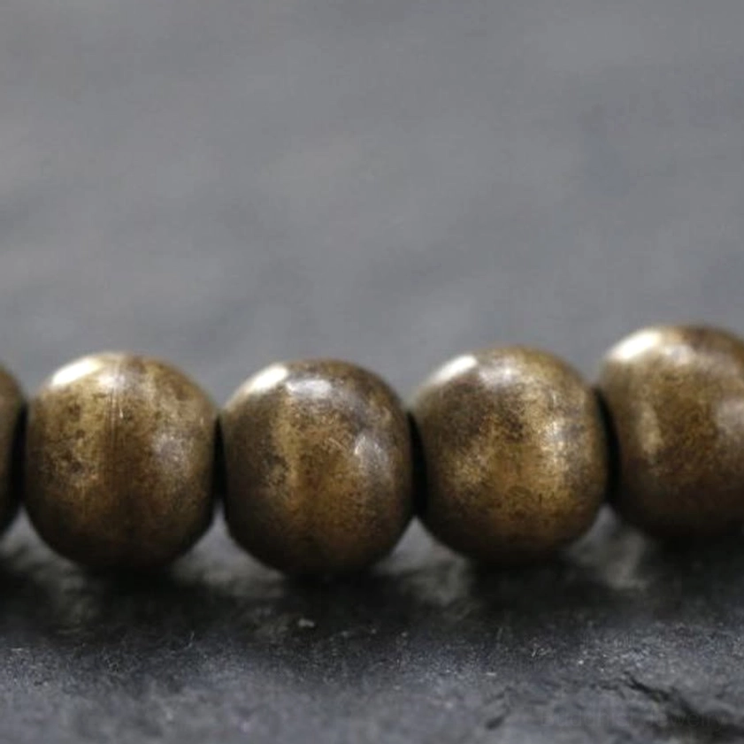 Large smooth matte bronze copper beads macro photography, close-up detail of 5mm polished round bead texture