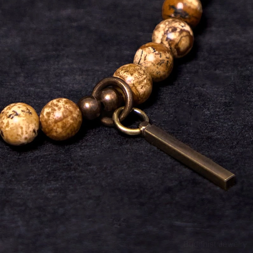 Copper jump ring and rectangular bar pendant charm detail of stone bead Buddhist bracelet