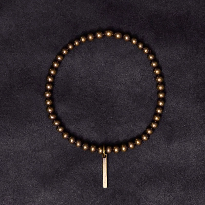 Full loop of copper brass beaded bracelet with hanging bar charm in dark bronze metallic finish