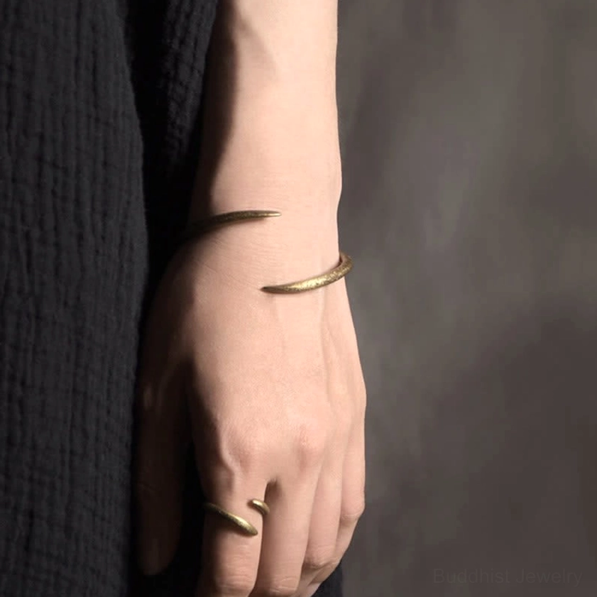 Copper cuff bracelet stacked with rings on hand, coordinating gold matte finish minimalist jewelry set
