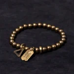 Handcrafted copper brass Buddhist bracelet front view with Good Luck charm and triangle clasp, antique bronze finish