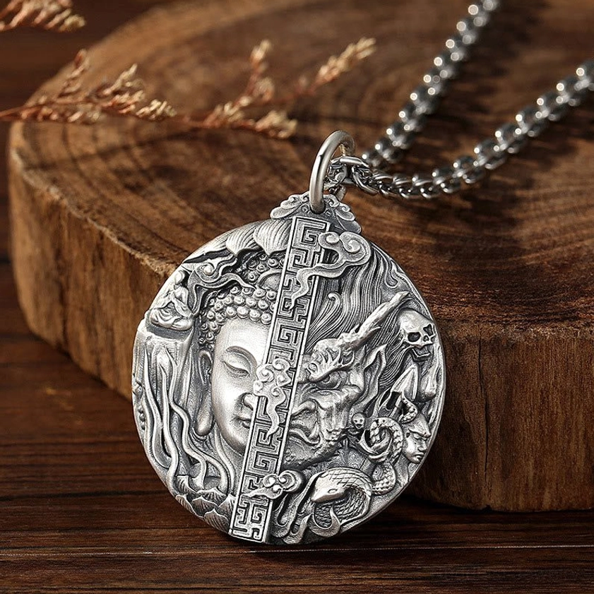 Buddhist copper pendant necklace left front angle showing sacred Buddha-demon relief carving with aged copper patina