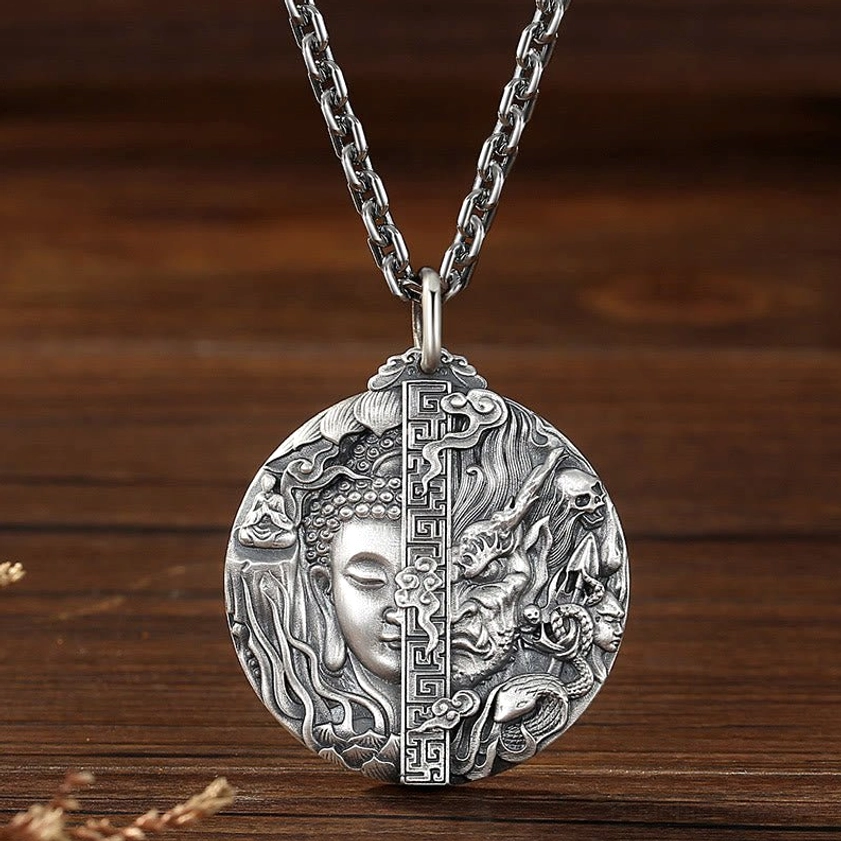 Buddhist copper pendant necklace front view with curb chain, displaying detailed relief carving of Buddha and demon symbolism