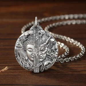 Copper Buddha and demon relief pendant necklace, three-quarter left angle view showing intricate carved details and aged copper finish