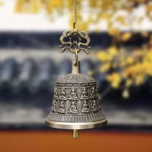Handcrafted copper Buddhist dragon wind chime bell with embossed Buddha reliefs and dragon top hanger, hanging view