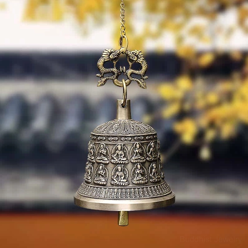 Handcrafted copper Buddhist dragon wind chime bell with embossed Buddha reliefs and dragon top hanger, hanging view