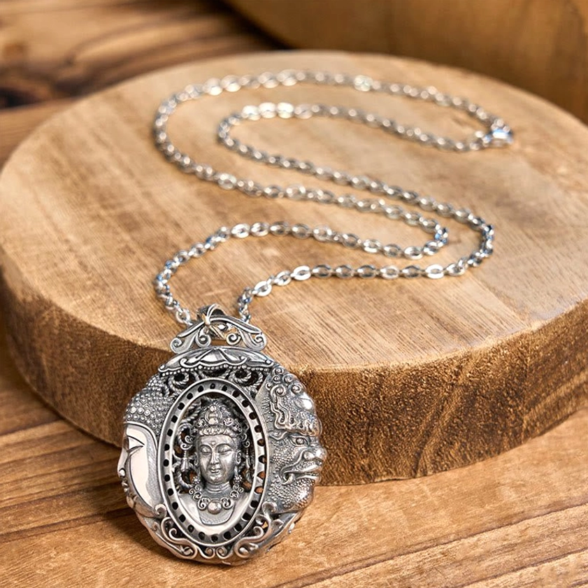 Buddhist pendant necklace oblique angle view on wooden stand, showing detailed carving and embossed Buddha symbol