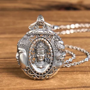 Handcrafted copper Buddha pendant necklace with dual-face carved design and intricate relief details, front view on wooden table