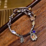 Copper Buddha braided rope compassion bracelet with ethnic beads and dual metal Buddha pendants, handcrafted spiritual jewelry