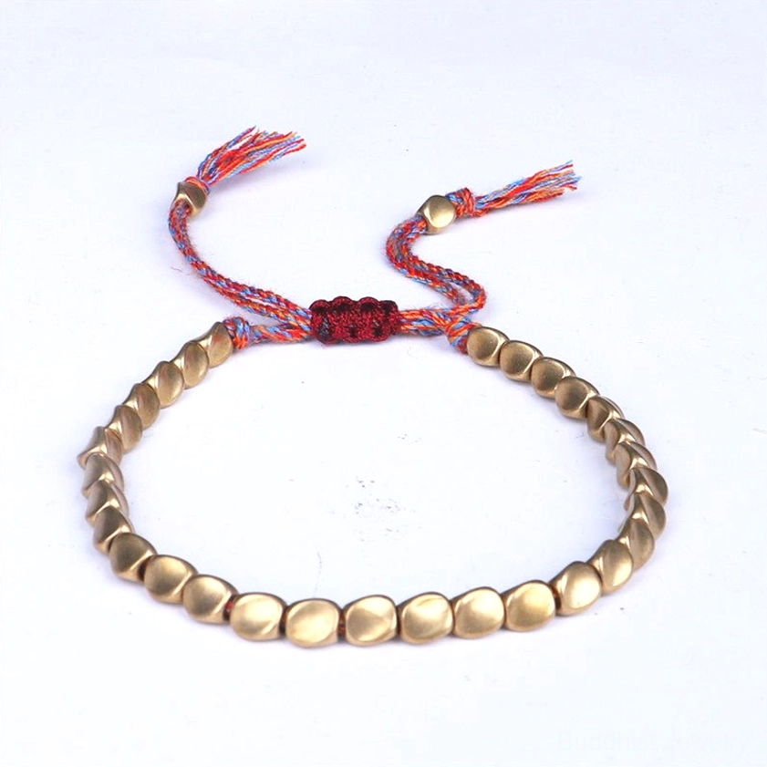 Shiny polished copper beads Buddhist bracelet with matte finish on light gray background showing detail