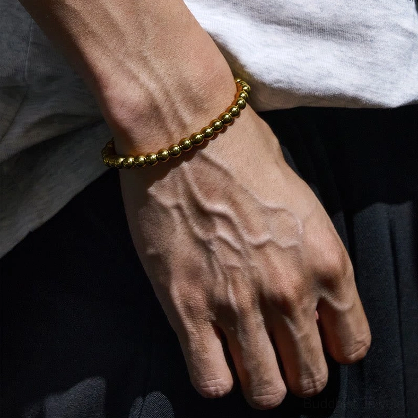 Copper brass beaded bracelet worn on wrist showing slim fitted style and golden bead luster