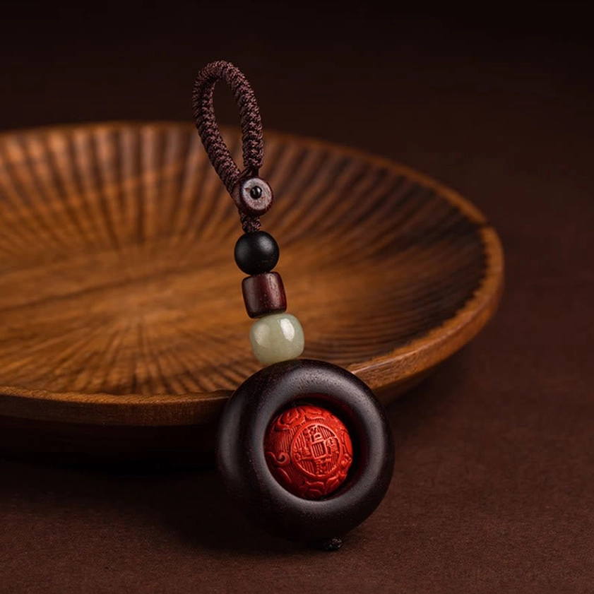 Copper coin charm variant of Buddhist protection keychain with traditional wealth symbol