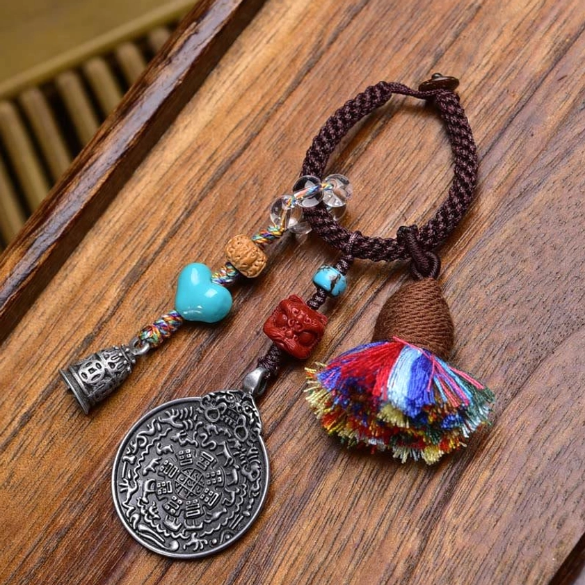 Copper Coins Buddhist keychain with dark brown braided rope, turquoise bead, and feng shui coins for prosperity