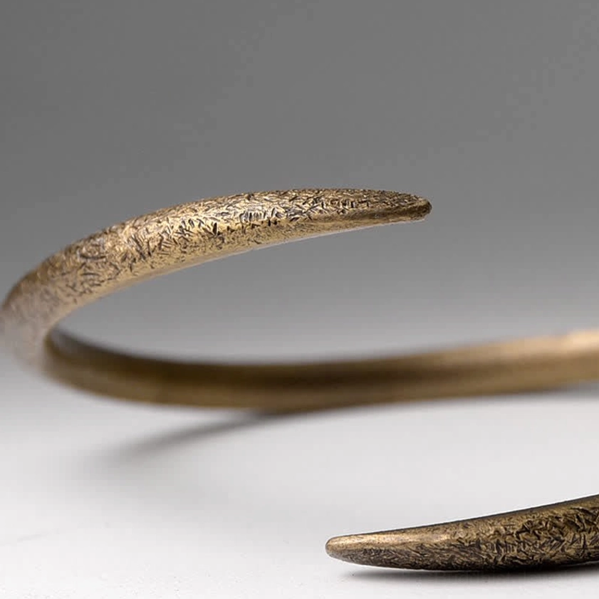 Adjustable copper cuff bracelet side profile showing textured matte finish and tapered open design