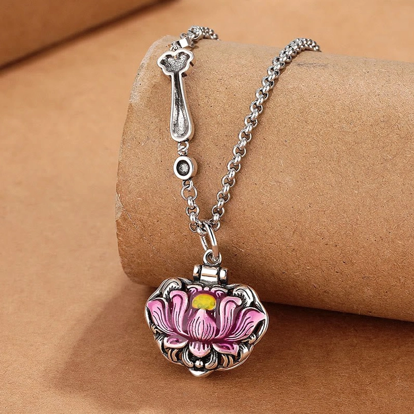 Copper lotus pendant necklace with pink enamel design, overhead artistic angle showcasing the delicate lotus flower symbolizing rebirth and new beginnings
