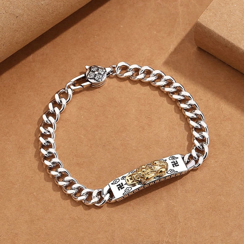 Buddhist wisdom bracelet with Pixiu and swastika symbols - top-down full view on kraft paper background