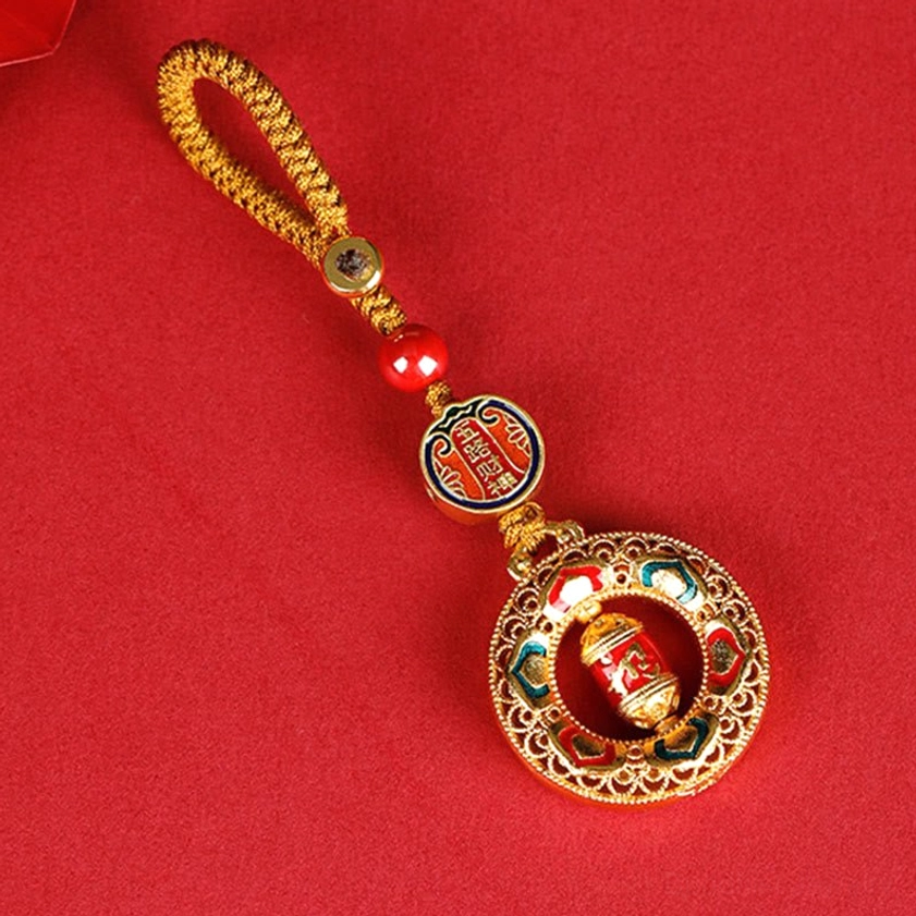 Copper prayer wheel keychain with Five Directions Gods of Wealth design, gold enamel detailing, red braided rope lanyard