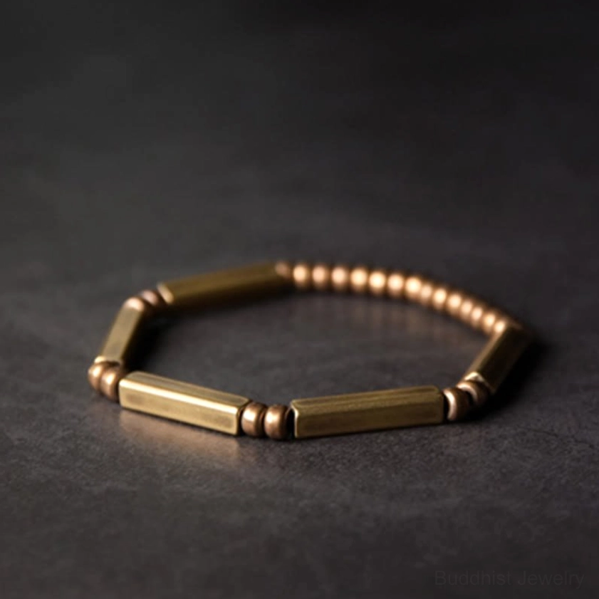 Single copper wealth bracelet flat lay top-down view, neatly arranged geometric beads on neutral background