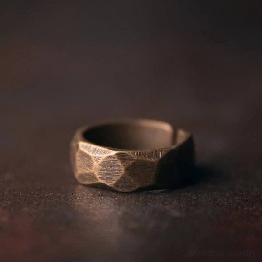 Copper prosperity ring 6mm width worn on finger showing minimalist Buddhist design and patina