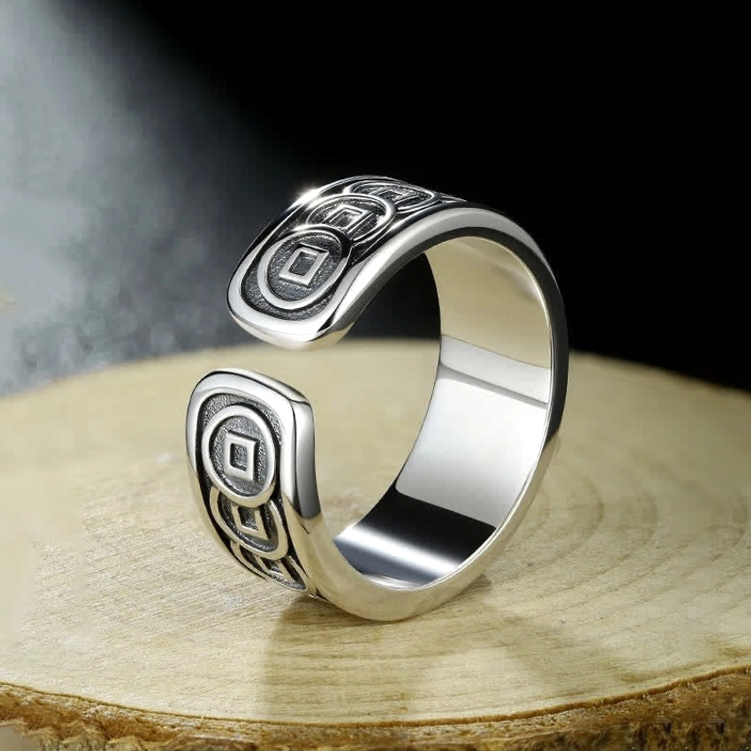 Side profile of open engraved Buddhist ring displaying polished silver interior and adjustable cuff design