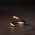 Adjustable copper spiral ring front view, antique gold finish, Buddhist protection ring close-up
