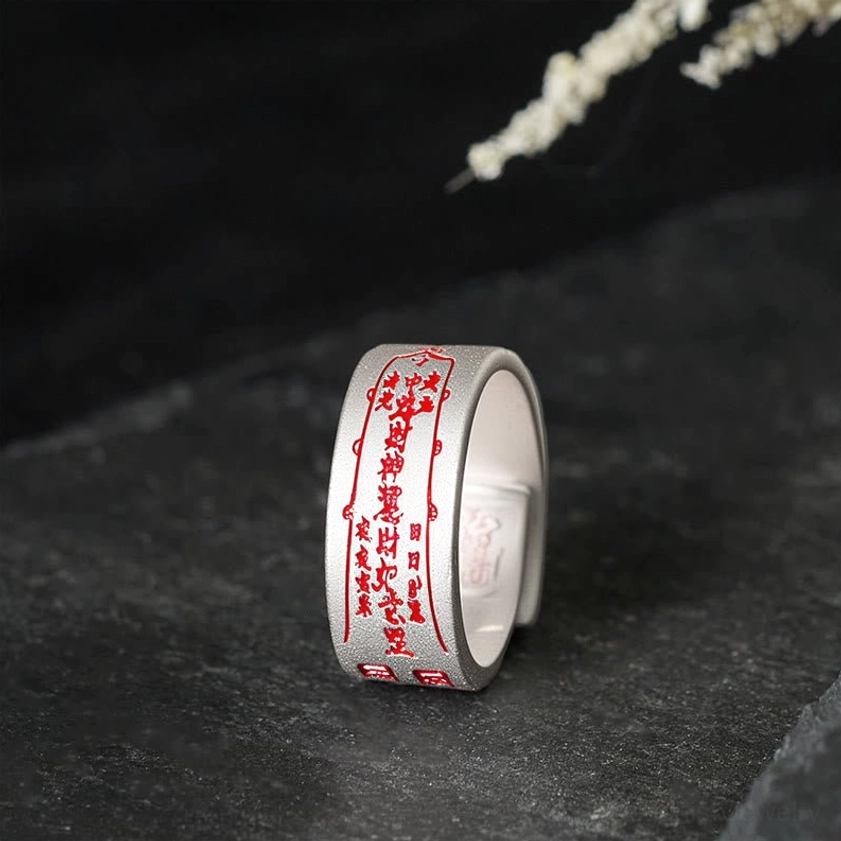 Copper talisman adjustable ring with sacred engravings shown in three-quarter side view, matte finish with red talisman patterns, open adjustable band design
