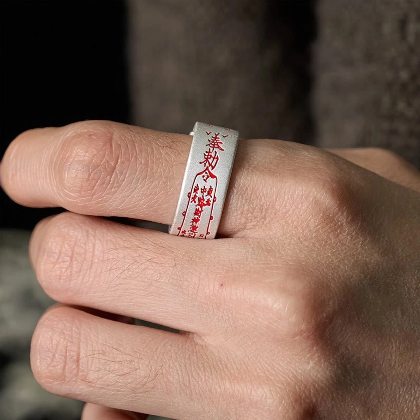 Copper talisman adjustable ring worn on finger close-up showcasing fit comfort and matte finish with red engraved details