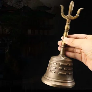Handmade copper meditation bell with vajra dorje handle and carved Bagua patterns, traditional three-quarter view showing detailed craftsmanship
