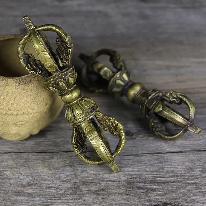 Pair of matching handcrafted copper vajra dorjes showing uniform bronze finish and ornate shaft carvings